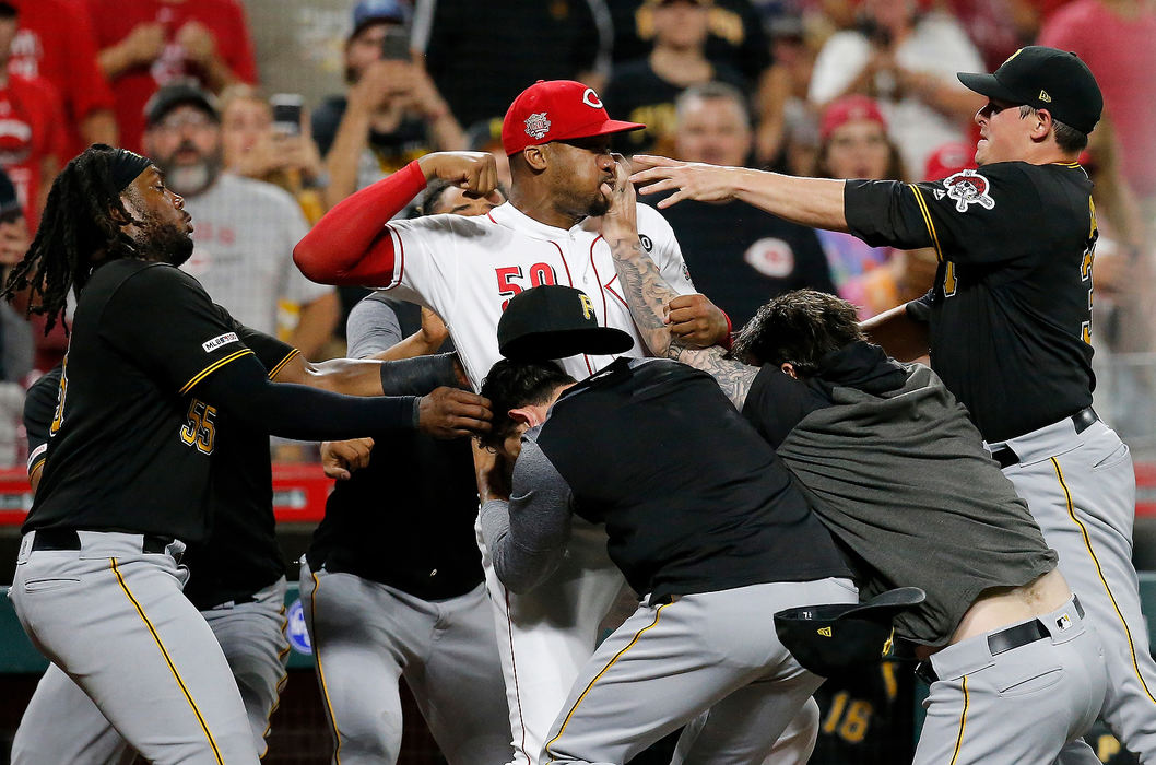 Sports Feature - 1st placeCincinnati Reds relief pitcher Amir Garrett (50) throws punches as he is held back by a number of Pittsburgh Pirates players as a bench clearing brawl breaks out in the ninth inning of a game at Great American Ball Park in Cincinnat. (Sam Greene/The Cincinnati Enquirer)