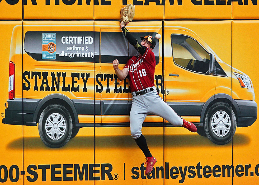 Sports - 1st placeAltoona Curve outfielder Chris Sharpe (10) crashes into the left field wall as he fails to catch a fly ball hit by RubberDucks batter Alex Call during the third inning of a game at Canal Park in Akron. (Jeff Lange/Akron Beacon Journal)