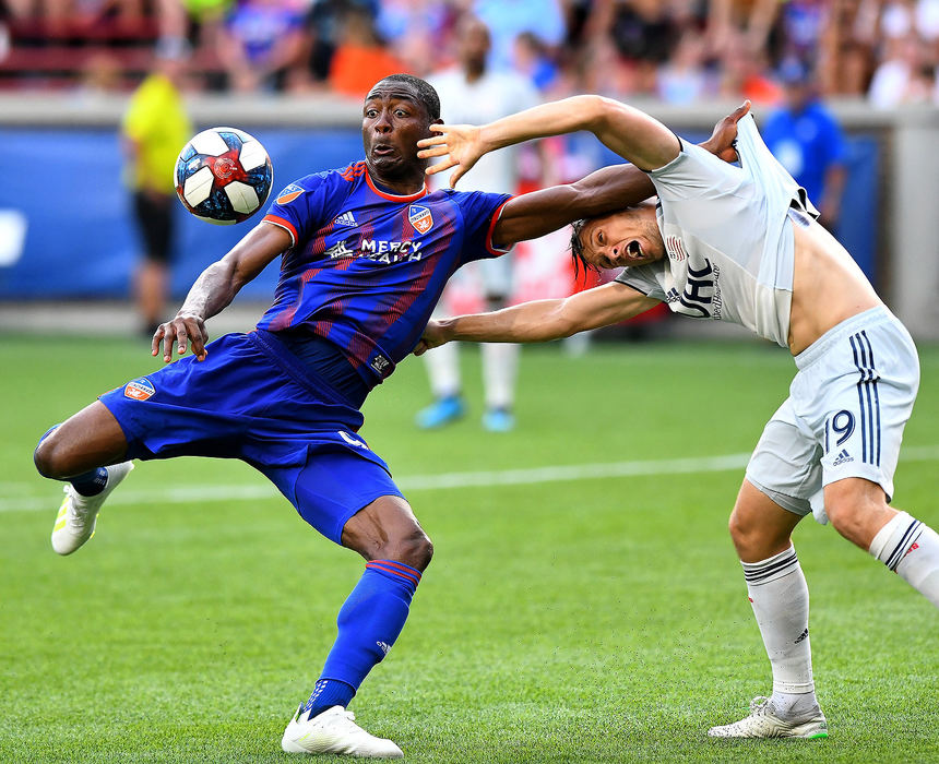 Sports - 2nd placeFC Cincinnati's Fanendo Adi attempts a shot on goal while trying to hold off New England Revolution defender Antonio Mlinar during the 2nd half of action at Nippert Stadiium in Cincinnati. (Erik Schelkun/Elsestar Images)