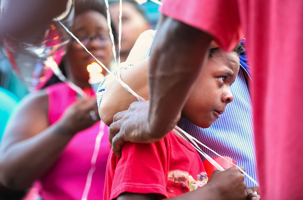 Story - 1st placeDe'Angelo Elston-Gambrell, 7, cries during a vigil for his dad Derjuan "PeeWee" Elston-Gambrell in Toledo. Derjuan was shot and killed on July 4 on the 2000 block of Elliott Avenue.  (Rebecca Benson/The Blade)