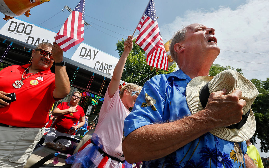 Story - 2nd placeMichael Doody sings the national anthem to kick off the start of the 26th annual Doo Dah Parade in the Short North July 4. The parade began in 1983 as a small, disorganized march down the sidewalks. The annual parade spoofs all things local as well as the nation. (Eric Albrecht/The Columbus Dispatch)