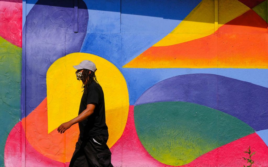 Feature - HM - Steven Stuart of Toledo walks on LaGrange Street while wearing a mask. Mr. Stuart says he is wearing a mask to comply with the mask mandate passed by city council amid the coronavirus pandemic.  (Jeremy Wadsworth / The Blade)