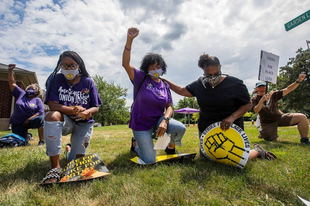 General News - HM - From left: Juliana Hunt, Jacqueline Hunt and Mae Loveri kneel for 8 minutes and 46 seconds in memory of Black people killed by police during ATU strike for Black Lives and workplace justice on South Detroit Avenue in Toledo. Amalgamated Transit Union (ATU) Locals and members across the country rallied for Black lives, and kneeled for 8 minutes and 46 seconds in memory of Black people killed by police.   (Rebecca Benson / The Blade)