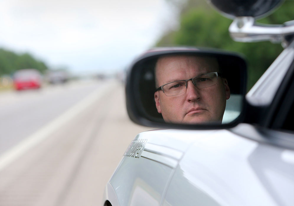 Portrait - 2nd place - Ohio State Highway Patrol Trooper Dwayne Shephard watches vehicles that don't obey the "Move Over Law" on U.S. Route 30 in Perry Township. The Ohio State Highway Patrol and state police in five other states are participating in a focus on education and enforcement of the "Move Over Law."  (Scott Heckel / The Canton Repository)