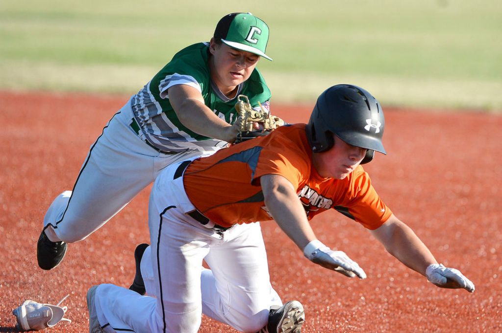 Sports - 2nd place - Celina’s Blayne Aller (7) dives to apply the tag on Coldwater’s Adam Hrycko (11) in the third inning at Montgomery Field in Celina. (Daniel Melograna / The Daily Standard)