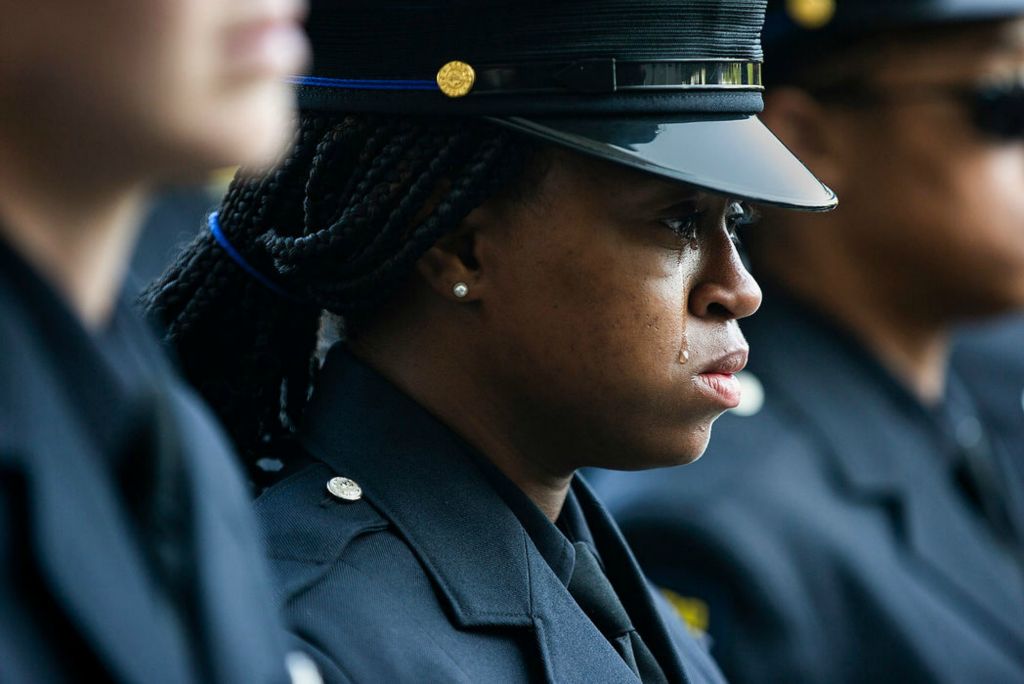 Story - 1st place - A Toledo Police Officer cries as officers carry slain Toledo police Officer Anthony Dia into Savage Arena at The University of Toledo. Toledo Police Officer Dia was killed in the line of duty in the early morning of July 4th. (Rebecca Benson / The Blade)