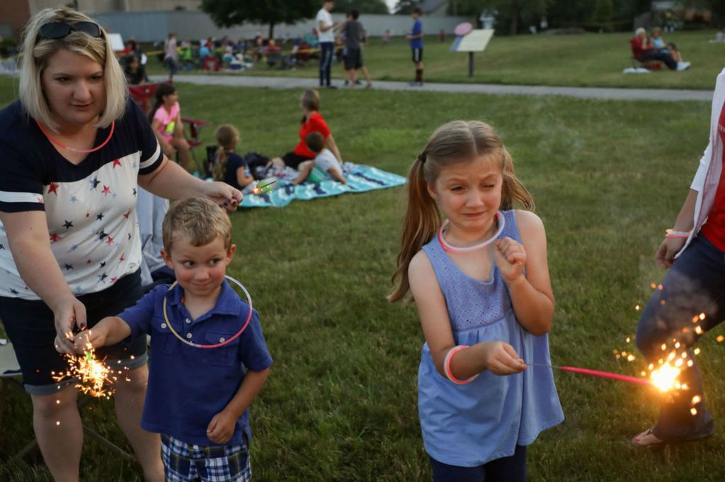 Feature - HM - Brody Roque, 4, watches as Kate Roque, 6, reacts to using a sparkler before the firework show in an early celebration of Independence Day at Fort Meigs in Perrysburg. (Kurt Steiss / The Blade)  