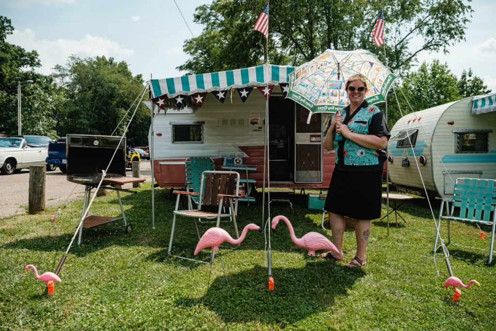 Portrait - 2nd place - West Creek resident Michelle Yoder poses for a portrait with her 1964 Shasta Camper named Ethel May, during the car show on the fourth day of New Philadelphia's First Town Day Festival. She is a member of the "Trailorettes," a traveling camper group – most of whom " ... use their campers all the time," according to Yoder. (Andrew Dolph / The Times Reporter)  