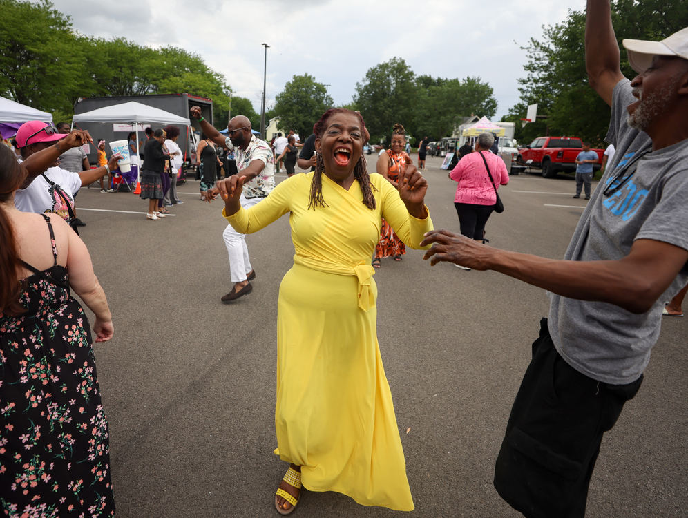 Feature - HM - Dorothy Gray (center) dances in the Soul Train Line with Tommy Wayne during the Players Ball Day Party, themed on the 1970s, in the parking lot at the Frederick Douglass Community Center in Toledo. (Kurt Steiss / The Blade)