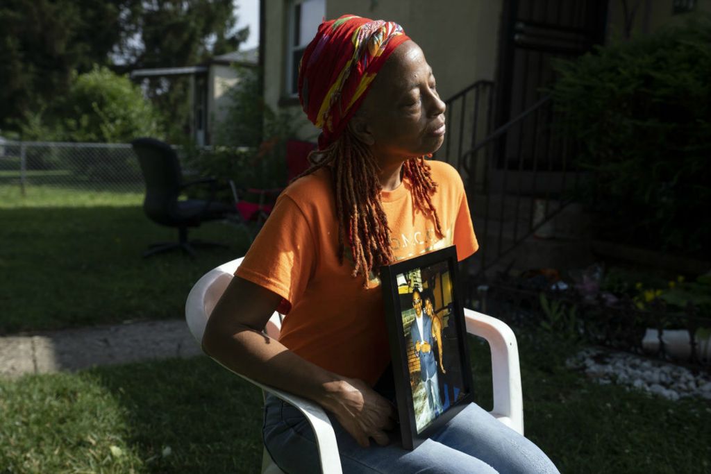 Portrait - 1st place - LaTonya Nichols holds a photo of her children Nofeir Cannon and A'Tayia Nichols who were both killed by gun violence. Nichols will be staying in a hotel room over the holiday weekend to avoid the sounds of fireworks in her neighborhood, which remind her of when she witnessed the murder of her daughter in 2022. (Brooke LaValley / The Columbus Dispatch)