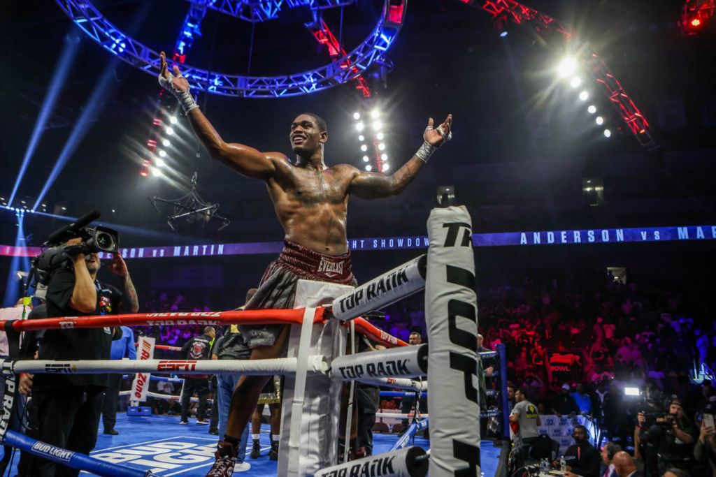 Sports Feature - 3rd place - Toledo native Jared Anderson climbs onto the ropes to the applause of a hometown crowd after seemingly securing a victory over former world champion Charles Martin of St. Louis, Mo. during a heavyweight battle for the WBO International and WBC USA titles at the Huntington Center in Toledo.  (Isaac Ritchey / The Blade)