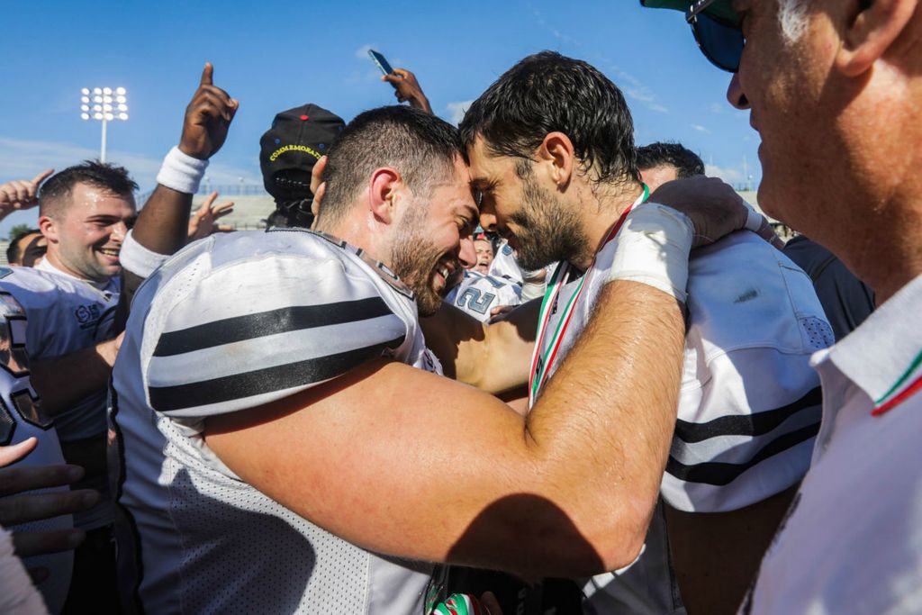 Sports Feature - HM - Parma Panthers’ Marcello Leone (left) and Tommaso Greci hug after defeating Florence Guelfi in the Italian Bowl XLII at the University of Toledo’s Glass Bowl. (Rebecca Benson / The Blade)