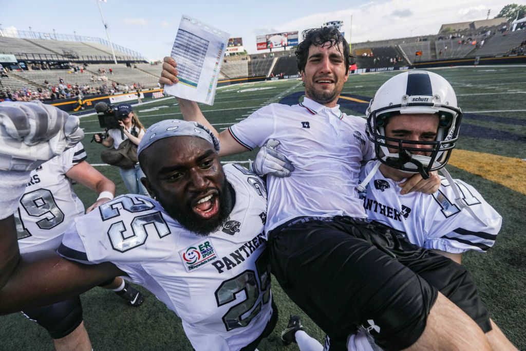 Story - 1st place - Parma Panthers’ Mpoko Titi (left) and Rocco Bonvicini carries offensive coordinator Sandrino Baci on their shoulders after defeating Florence Guelfi in the Italian Bowl XLII at the University of Toledo’s Glass Bowl. (Rebecca Benson / The Blade)