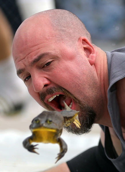 General News - 2nd place - Shawn Wright of Wadsworth motivates his frog Stormy during the 63rd annual Valley City Frog Jump festival in Valley City. (Jeff Lange / Akron Beacon Journal)