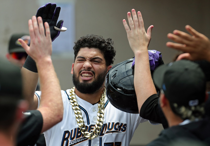 Sports Feature - 2nd place - Akron Rubber Ducks right fielder Alexfri Planez celebrates with his teammates in the dugout after his solo homer against the Bowie Baysox during the sixth inning of a AA Minor League game at Canal Park in Akron. (Jeff Lange / Akron Beacon Journal)