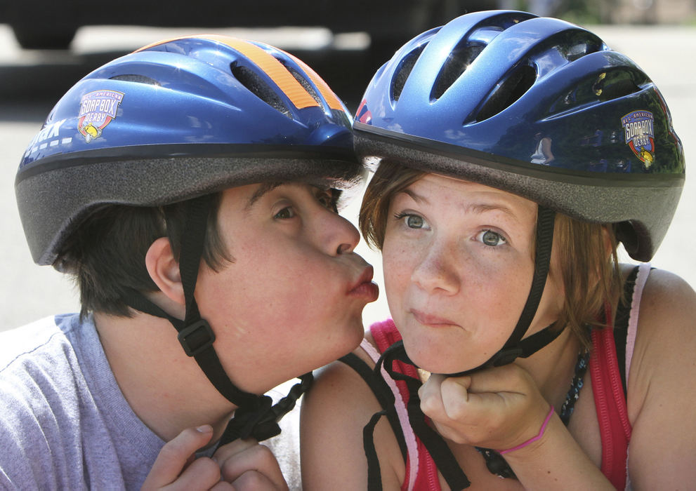 Feature - 3rd place - John-John Pazdzior (left) steals a kiss for good luck from his driver Kendal Allen before his race down the Soap Box Derby hill at Big Run Park in Columbus. Twelve children participated in the annual Super Kids Race where children with special needs get to participate in the contest as the co-pilots.  (Neal C. Lauron / The Columbus Dispatch)