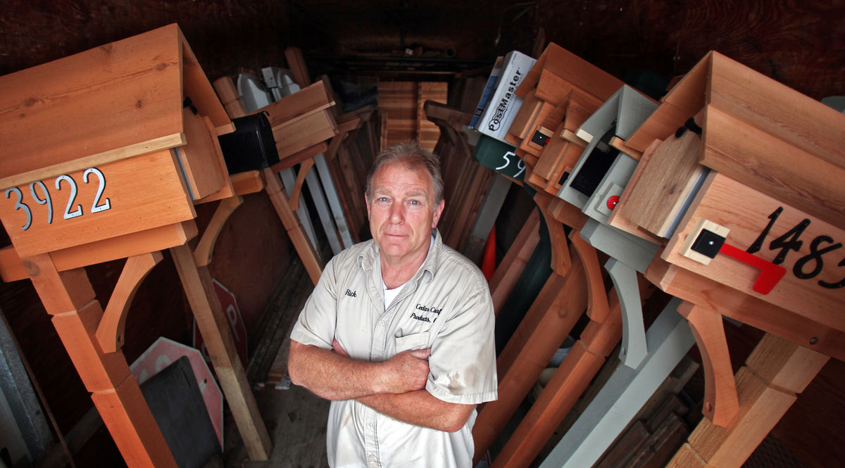 Portrait - 2nd place - Rick Van Walsen owner of  Cedar Craft in Blacklick with some of his finished cedar mailboxes. (Tom Dodge / The Columbus Dispatch)