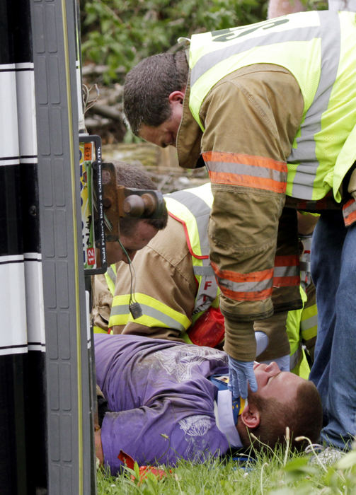 Spot News - 3rd place - The Ohio State Highway Patrol, the Clark County Sheriff's office, and Springfield Township Fire and Rescue personnel responded to a single-vehicle rollover crash in Springfield. The 18-year-old male driver lost control of the vehicle and was ejected as the SUV rolled over. He was taken by medic to Springfield Regional Medical Center with non-life-threatening injuries.  (Barbara J. Perenic / Springfield News-Sun)