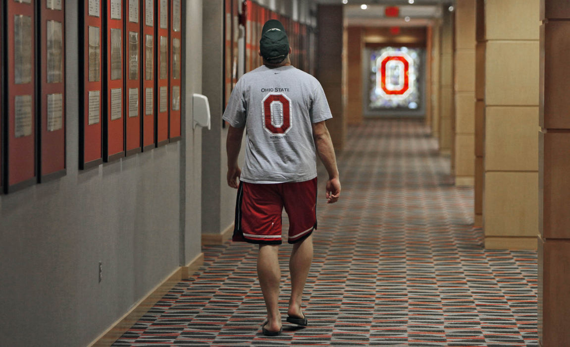 Sports - 1st place - Ohio State University quarterback   Joe Bauserman walks away from a news conference held at the Woody Hayes Athletic Center on June 28. (Chris Russell / The Columbus Dispatch)