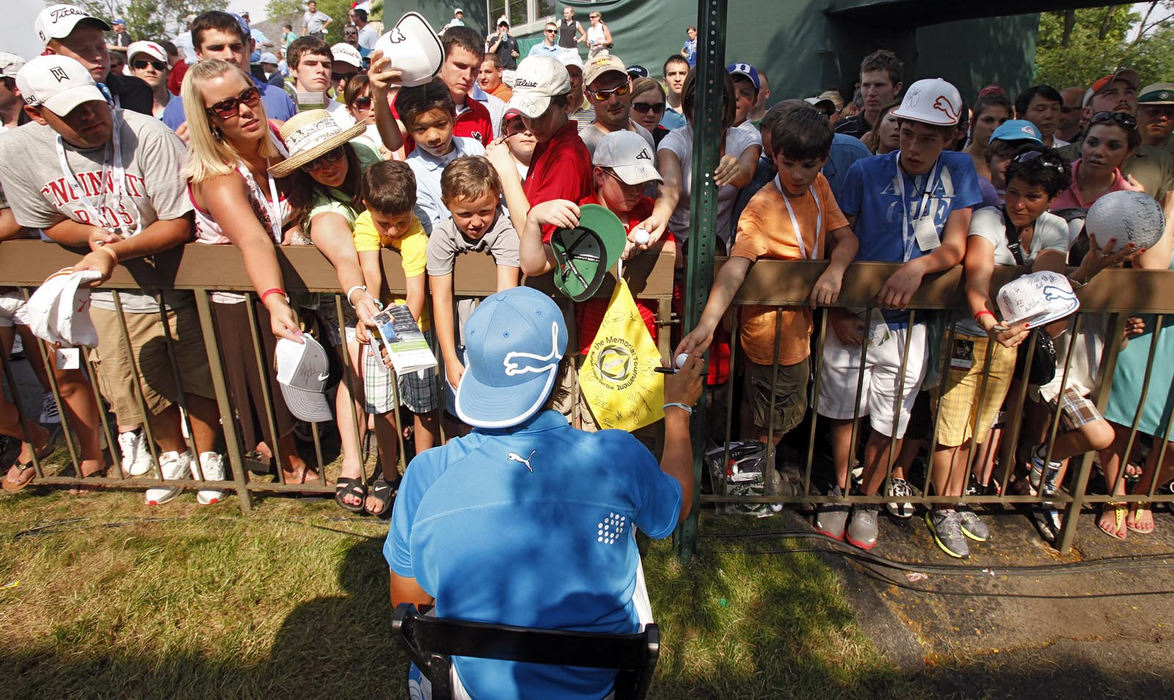 Story - 2nd place - Rickie Fowler signs autographs while sitting in a chair after finishing the 3rd round at the 2011 Memorial tournament at Muirfield Village Golf Club in Dublin. (Kyle Robertson / The Columbus Dispatch)