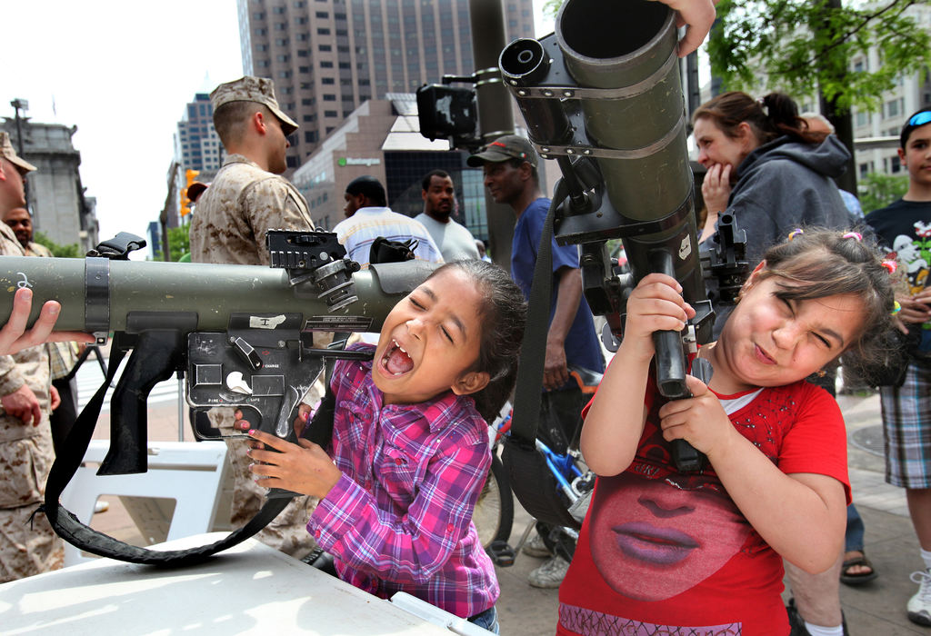 General News - 1st placeBarely able to lift the launchers, Binita Biswa, 8, left, and her friend Zaineb Ramahdan, 8, get a first-hand look at some of the weaponry on display near Public Square as the week-long Marine Week Cleveland kicked off.  The shoulder-launched multi-purpose assault weapons were among the dozens of state-of-the-art weaponry and equipment that the public could handle under the watchful eyes of Marines.   ( Lisa DeJong / The Plain Dealer)