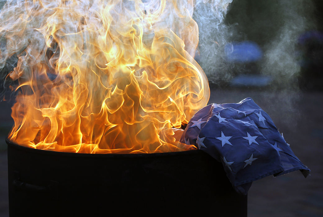 Story - 1st placeAn American flag burs during its retirement ceremony at First Responders Park in Westerville on Flag Day. (Adam Cairns / ThisWeek Newspapers)