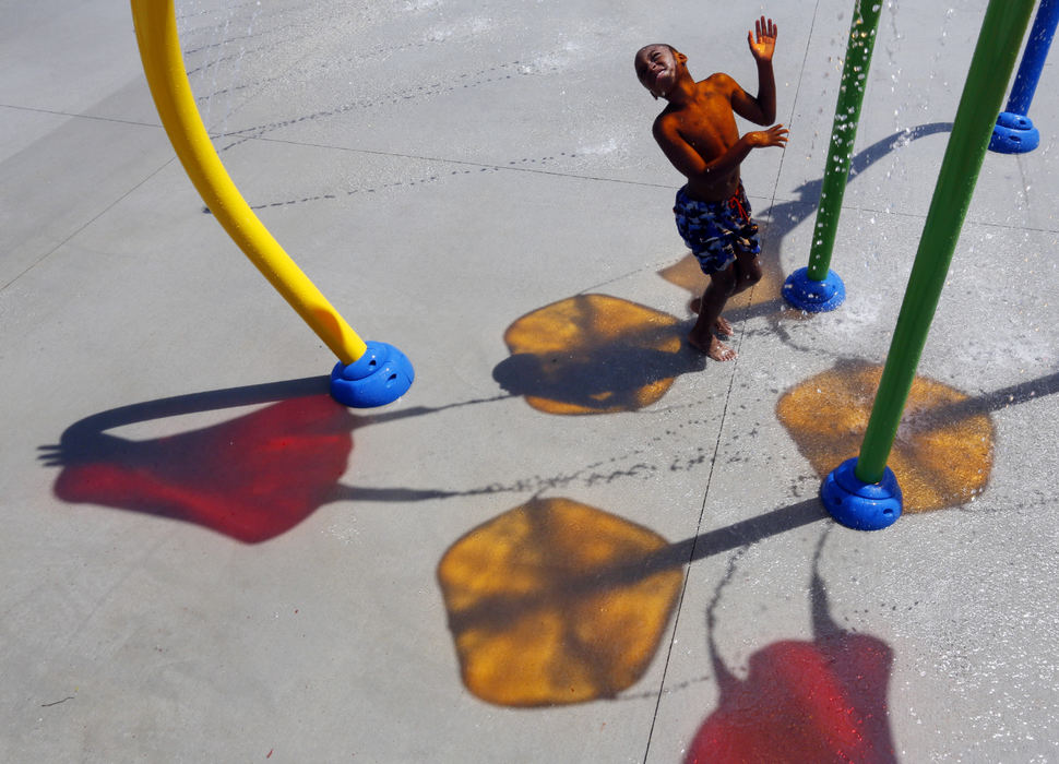 Feature - 2nd placeKaden Jones, 9, of Columbus soaks up the water and sun at the new Blackburn Rec Center splash pad. (Eric Albrecht / The Columbus Dispatch)