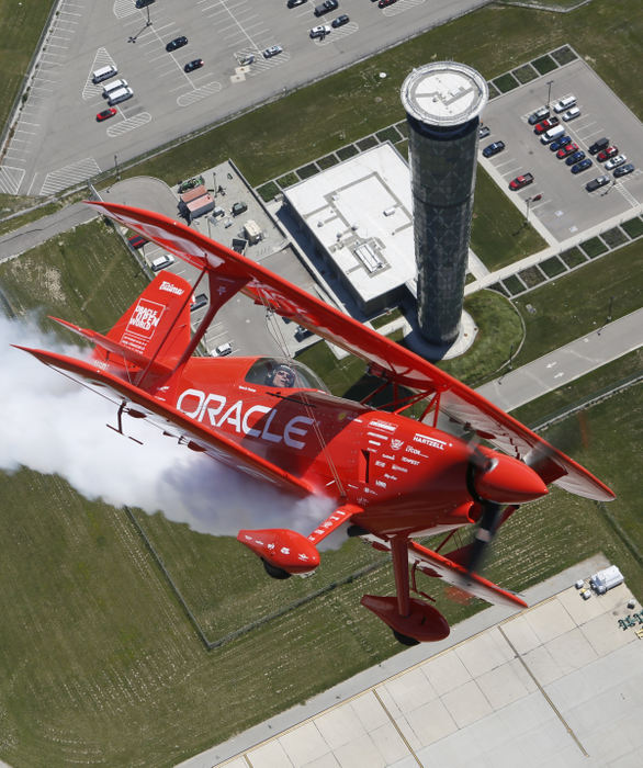 General News - 2nd placeIn preparation for the Vectren Dayton Air Show being held June 22-23, Sean D. Tucker pilots the Oracle Challenger III aerobatic bi-plane over the control tower at Dayton International Airport. WIth military aerial teams being grounded due to the Congressional-mandated sequestration, Tucker is one of many featured civilian pilots who will be performing.  (Adam Cairns / The Columbus Dispatch)