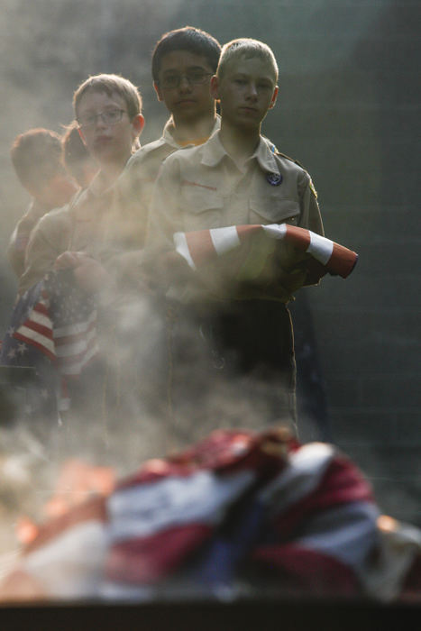 General News - 3rd placeSpencer Moledor, 12, (right) of Pickerington, Anayus Weber, 11, (center) of Reynoldsburg, and Grant Boone, 10, (left) of Reynoldsburg, watch as American flags are burned during Boy Scout Troop 826's flag retirement ceremony at VFW Post 9473 in Reynoldsburg. (Joshua A. Bickel / ThisWeek Newspapers)