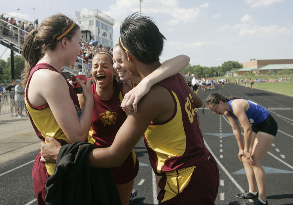 Sports Feature - 3rd placeWesterville North's Haley Sandvik, Heidi Engelhardt, Heather Sandvik, and Jocelyn Sharpe celebrate winning the 4x800 meter relay at the 2013 OHSAA Division I regional championship at Pickerington North. (Lorrie Cecil / ThisWeek Newspapers)