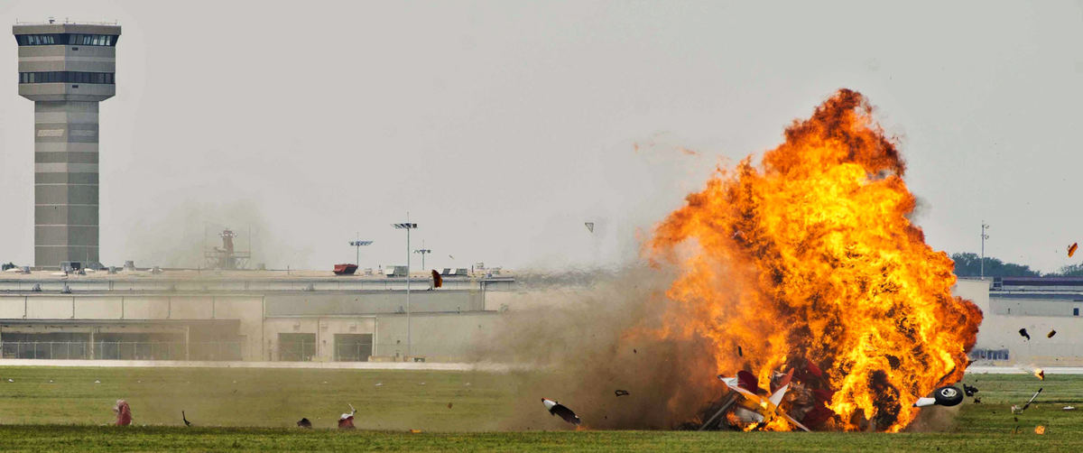 Spot News - 1st placeA vintage stearman aircraft carrying wing walker Jane Wicker and pilot Charlie Schwenker crashes at the Vectren Dayton Air Show in front of a crowd of spectators. Both Wicker and Schwenker were fatally injured in the crash. (Isaac Hale / Ohio University)