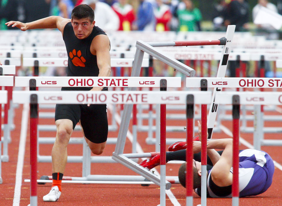 Sports - 1st placeTaylor Cordell of West Liberty-Salem is inadvertently tripped up as Matt Hodge of Valley falls during the 110 meter hurdles at the OHSAA track and field championships in Columbus. (Barbara J. Perenic / Springfield News-Sun)