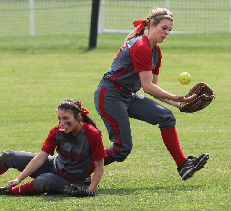 Sports - 2nd placeElyria shortstop Marie Masters (left) and left fielder Holly Howser collide missing a fly ball off the bat of Hoover's Kathleen Shier in the second inning of the Division I state softball championship game at Firestone Stadium in Akron. The Vikings went on to win the game 7-0.  (Phil Masturzo / Akron Beacon Journal)