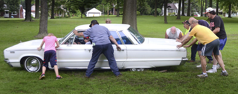 General News - 3rd place - Cody Mitchell of Hanoverton tries to drive a 1965 Dodge Custom 880 owned by Mike Huzicko of Struthers out of the mud at Centennial Park in Salem at the Salem Super Cruise. (Patricia Schaeffer / The (Lisbon) Morning Journal)