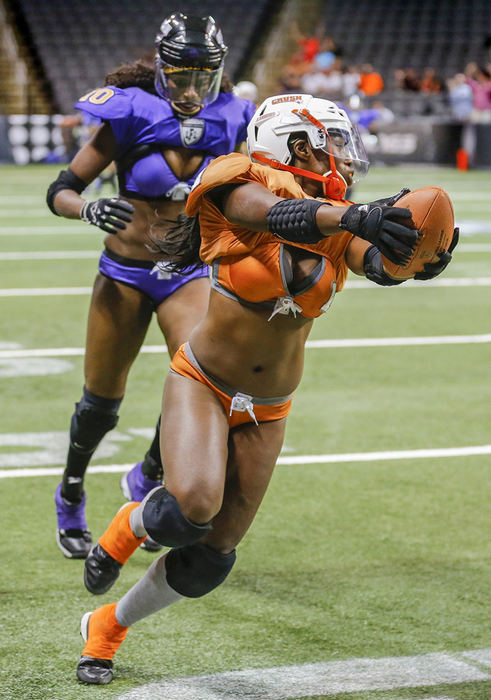 Story - 2nd place - Toledo Crush player Tamar Fennell (1) beats Baltimore Charm player Jessica Johnson (10) for a touchdown on the first play of the game at the Huntington Center.   (Andy Morrison / The (Toledo) Blade)