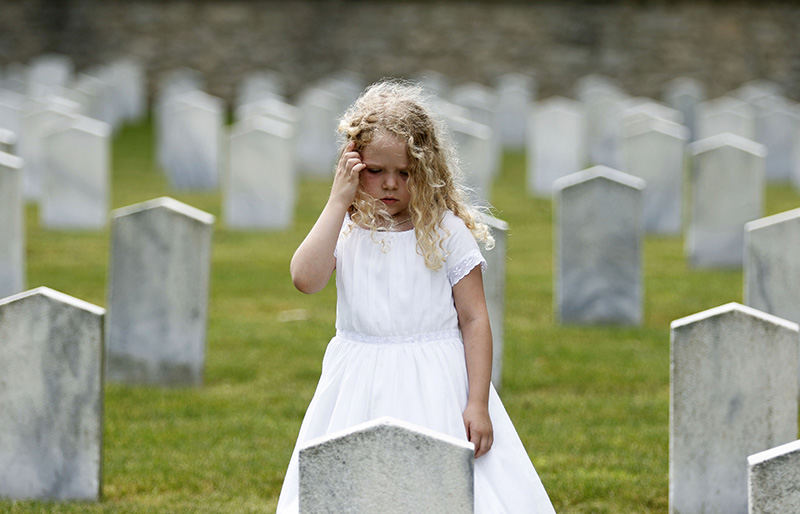 Feature - 3rd place - Agatha Horstman, 7, of Cincinnati looks for a 44th Alabama Stone at the 119th Annual Camp Chase Confederate Cemetery Memorial Ceremony in Columbus. (Leah Klafczynski / The Columbus Dispatch)