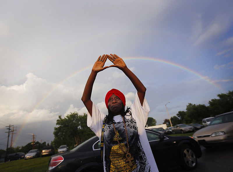 General News - 1st place - Tina Dailey, who grew up in the Linden neighborhood, listens to a prayer during a vigil near the home of Michael A. Ballour who was killed along with three others in his home on East Hudson Street. (Jonathan Quilter / The Columbus Dispatch)