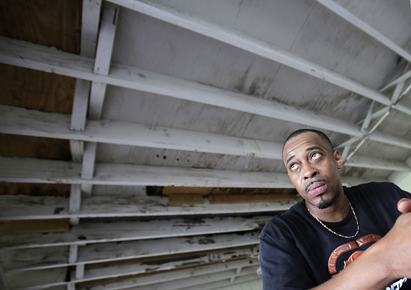 Portrait - 2nd place - Sean Thompson talks about how he manages his rent and the remainder of his personal expenses while seeking shelter from the rain in his apartment's garage in Canton. (Scott Heckel / The (Canton) Repository)