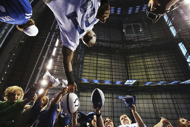 Sports Feature - 2nd place - Cornerback Vontae Davis (21) signs autographs for fans before public practice at the annual Indianapolis Colts mini-camp and fan open house at Lucas Oil Stadium in Indianapolis. (Jenna Watson / Kent State University)