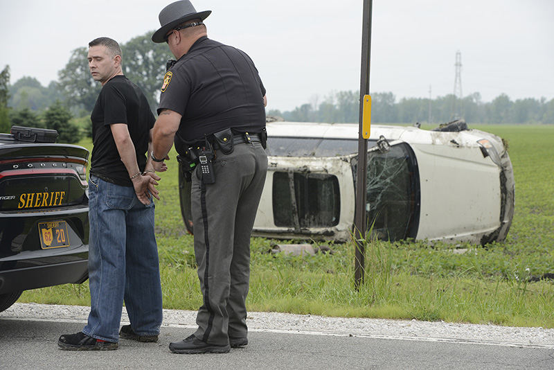 Spot News - 3rd place - Sgt. Kent Davis, of the Ottawa County Sheriff’s Office, arrests William Mitchell after a single-vehicle crash. Mitchell reportedly turned onto County Road 17 from Ohio 53, drove off the road and rolled his car several times in a field. (Molly Corfman / The News-Messenger)