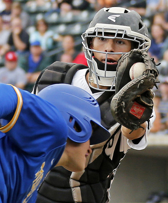 Sports - 3rd place - Westerville Central catcher Austin Kondratick (23) chases down Patrick Mullinger (18) of Moeller in their Division I state baseball championship game at Huntington Park in Columbus. (Barbara J. Perenic / The Columbus Dispatch)