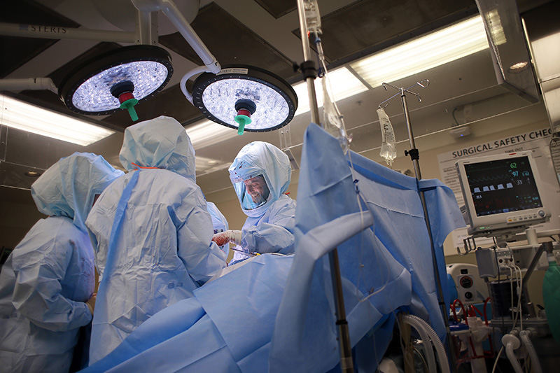 AStory - 1st place - On his seventh, and final, surgery of the day, orthopedic surgeon Brian Cohen still manages to have a smile on his face while performing a total hip replacement at Adena Health System in Chillicothe. (Adam Cairns / The Columbus Dispatch)