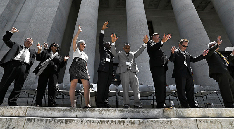 Story - 3rd place - Pastors stand for the final prayer along the steps of the Ohio Statehouse as Ohio 7:14, a Solemn Assembly of Prayer, which drew over five hundred people to the Ohio Statehouse in downtown Columbus on June 11.  (Barbara J. Perenic / The Columbus Dispatch)