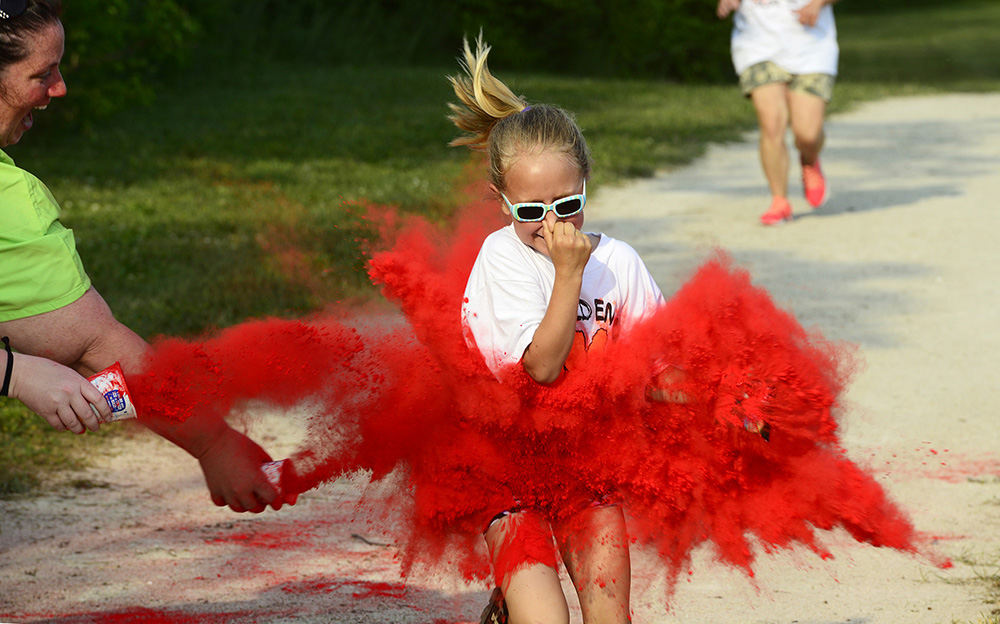 Feature - 3rd place - Ashlyn Wightman, 7, of Gibsonburg runs in the Golden Bear Color Run competing in her first run. (Molly Corfman / The News-Messenger)