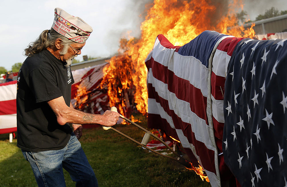 General News - 1st place - American Legion Post 286 in New Carlisle held their annual Flag Day flag retirement ceremony. The American Legion retired over 9,000 flags this year by burning them. More than 200 spectators watched as the flags went up in flames. The smoke from the fire could be seen for miles away.  (Bill Lackey / Springfield News-Sun)