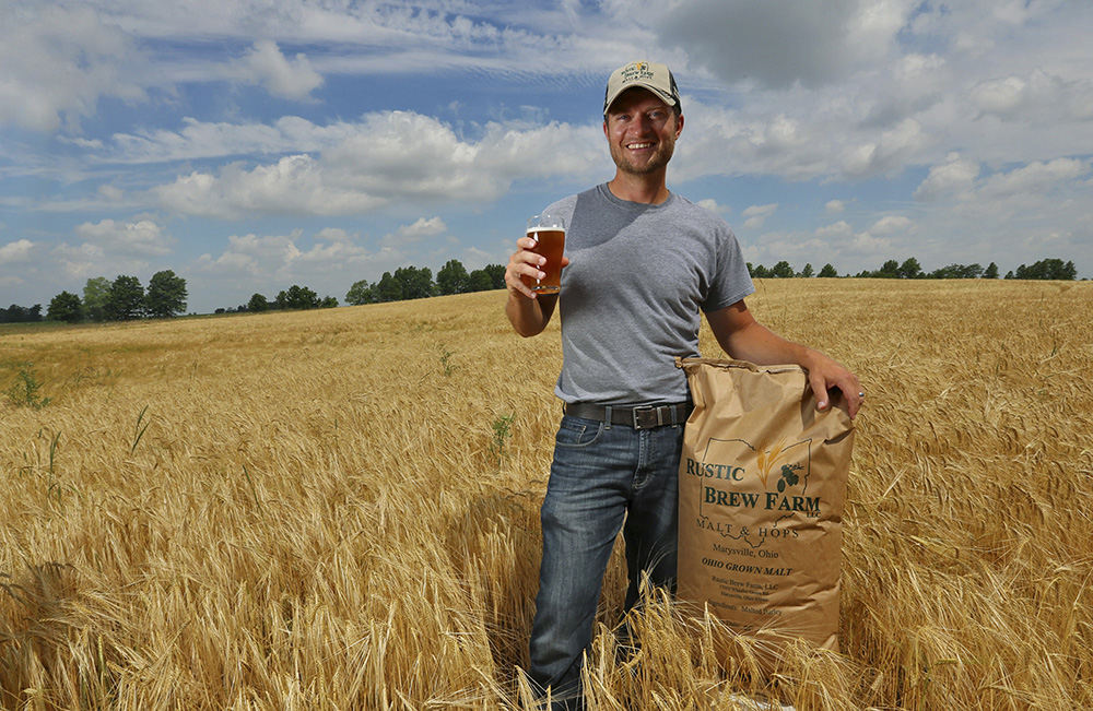 Portrait - 3rd place - Matt Cunningham of Rustic BrewFarm near Marysville with his crop of barley and a beer made with his crop by a local brewery. Matt is turning part of his farm into crops for the local craft beer making industry. (Eric Albrecht / The Columbus Dispatch)