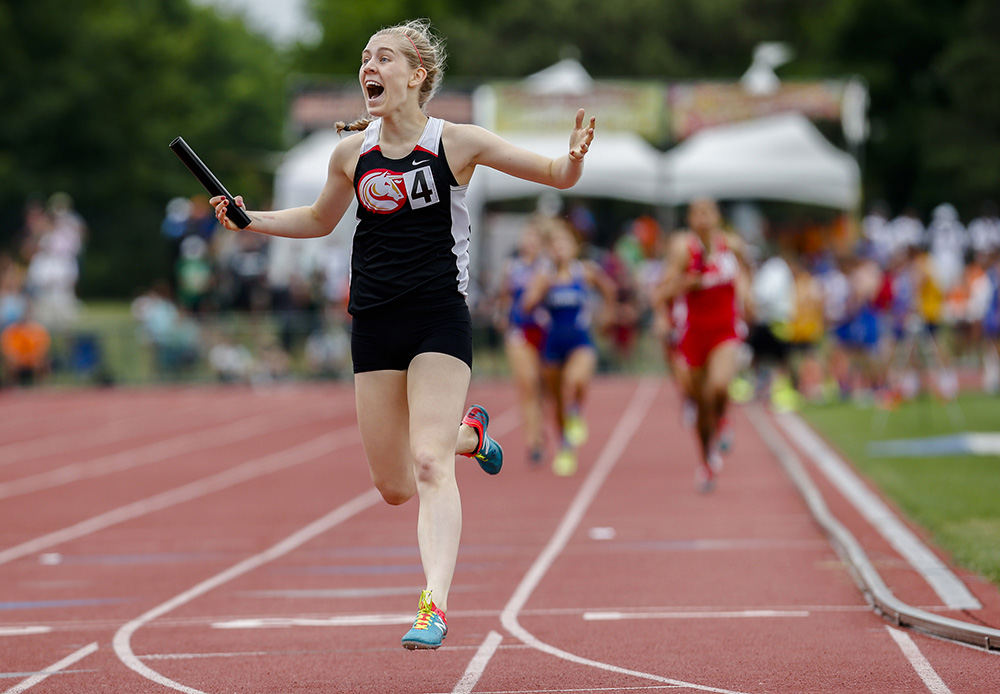 SPSports Feature - 2nd place - Columbus School for Girls's Eleanor Smith celebrates after winning the 4x400-meter relay at the OHSAA Division II track and field state championships at Jesse Owens Memorial Stadium in Columbus. Columbus School for Girls won the event with a time of 3 minutes - 54.28 seconds. (Joshua A. Bickel / ThisWeek Community News)