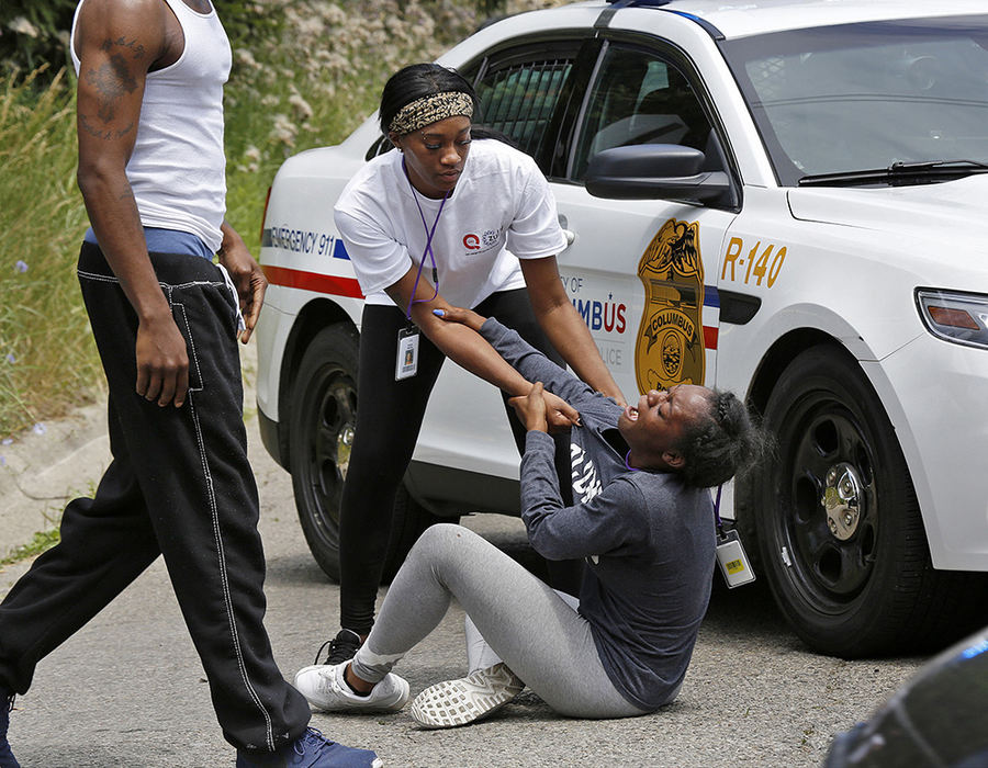 Spot News - 2nd place - People react at the scene of a fatal shooting in the 4100 block of Larry Place, a cul-de-sac south of E. Livingston Avenue. Columbus Police are investigating the shooting as a homicide.  (Barbara J. Perenic / The Columbus Dispatch)