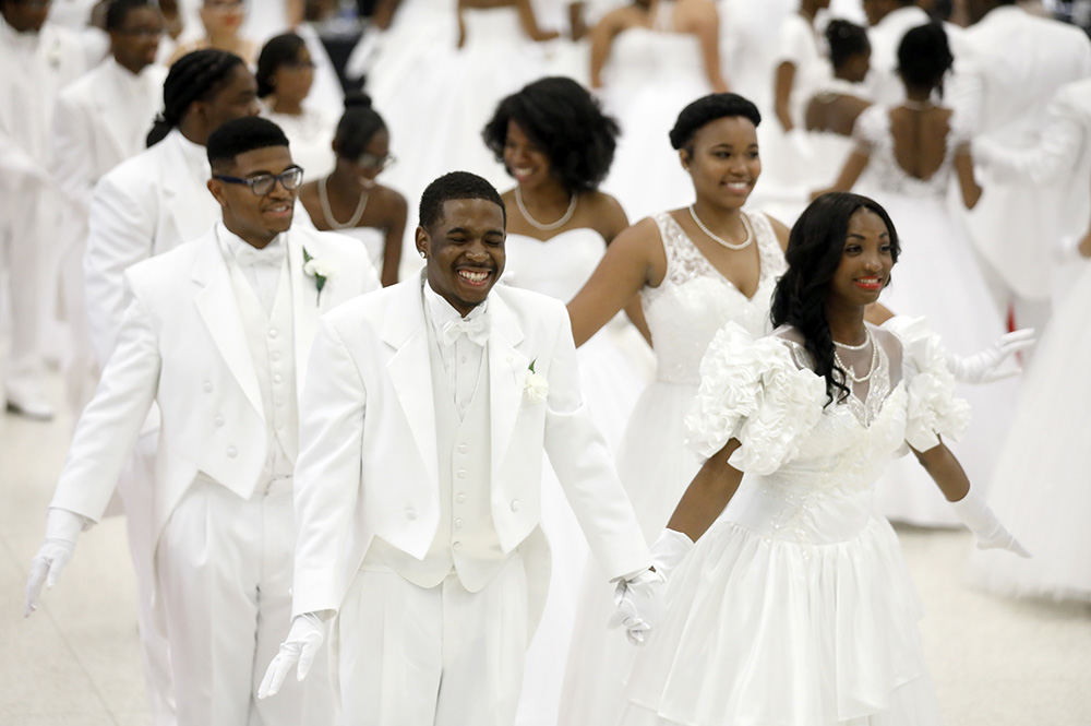 Feature - 1st place - Diamond Fears and her escort John Reynolds have a laugh as they make a mistake during the waltz at the 52 annual Debutante Cotillion presented by the National Assoc. of the Negro Business and Professional Women's Club's Inc., Toledo Chapter at the Great Hall at the Stranahan Theater.  (Andy Morrison / The Blade)