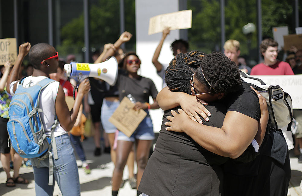 AGeneral News - 2nd place - Dozens of people gather to protest the arrests that were made at the Columbus Pride Parade outside the Franklin County Courthouse. The four individuals arrested in front of City Hall were attempting to halt the parade for seven minutes “to create awareness of the lack of spaces for queer people of color in Columbus and the police presence at Pride,” according to one of the protest organizers. (Adam Cairns / The Columbus Dispatch)